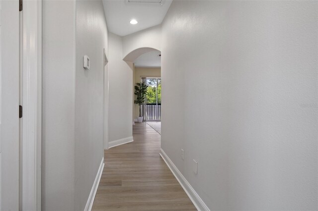 27318 Sora Blvd, Wesley Chapel, FL 33544 - hall featuring arched walkways, recessed lighting, baseboards, and light wood-style floors