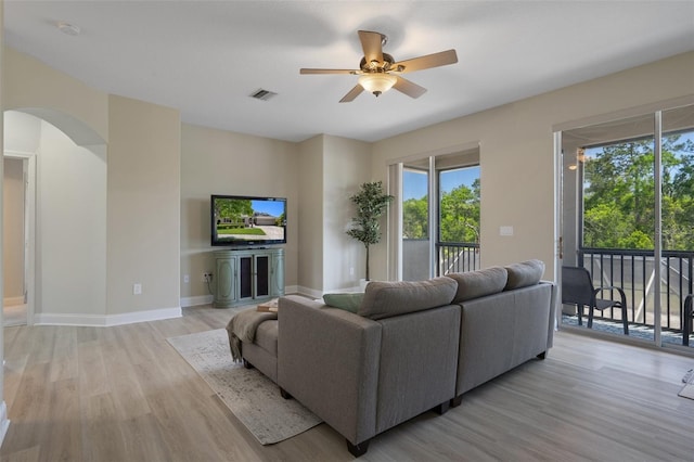27318 Sora Blvd, Wesley Chapel, FL 33544 - living area with visible vents, a ceiling fan, arched walkways, a wealth of natural light, and light wood-style flooring