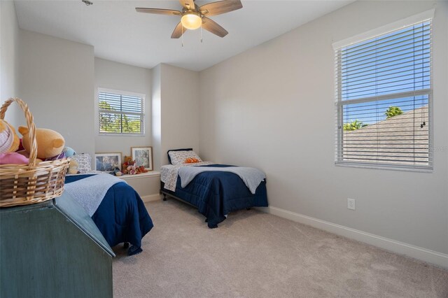 27318 Sora Blvd, Wesley Chapel, FL 33544 - bedroom with light carpet, baseboards, and ceiling fan