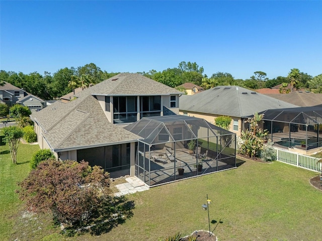 27318 Sora Blvd, Wesley Chapel, FL 33544 - back of house featuring a patio area, a shingled roof, glass enclosure, and an outdoor pool