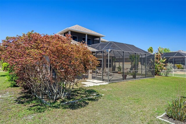 27318 Sora Blvd, Wesley Chapel, FL 33544 - rear view of house featuring a lawn, fence, a lanai, and a patio