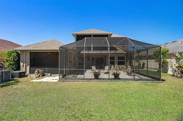 27318 Sora Blvd, Wesley Chapel, FL 33544 - rear view of property featuring central air condition unit, a yard, a patio area, and a lanai