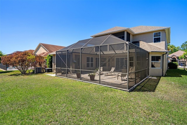 27318 Sora Blvd, Wesley Chapel, FL 33544 - rear view of house with central AC unit, a yard, stucco siding, a patio, and roof with shingles