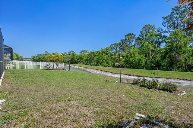 27318 Sora Blvd, Wesley Chapel, FL 33544 - view of yard featuring fence and glass enclosure