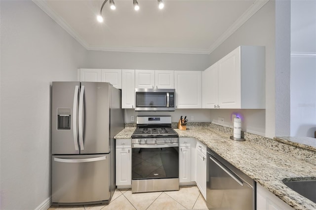 2739 Via Capri Unit 1024, Clearwater, FL 33764 - kitchen with appliances with stainless steel finishes, light stone counters, white cabinets, ornamental molding, and light tile patterned floors