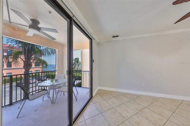 2739 Via Capri Unit 1024, Clearwater, FL 33764 - empty room with ornamental molding, a ceiling fan, plenty of natural light, and light tile patterned floors
