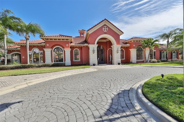 2739 Via Capri Unit 1024, Clearwater, FL 33764 - mediterranean / spanish home featuring a tile roof and stucco siding
