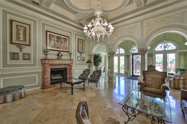 2739 Via Capri Unit 1024, Clearwater, FL 33764 - living area featuring ornate columns, a decorative wall, a chandelier, coffered ceiling, and a towering ceiling