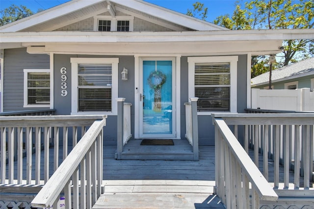 view of exterior entry featuring a deck