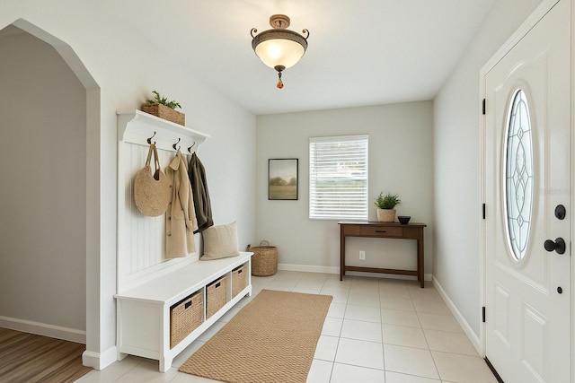 mudroom with baseboards and light tile patterned flooring