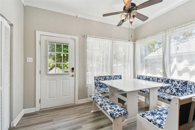 dining room with ceiling fan, baseboards, and wood finished floors