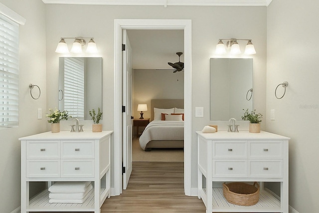full bath with two vanities, wood finished floors, ceiling fan, and ensuite bathroom