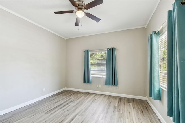 spare room with baseboards, ornamental molding, and wood finished floors