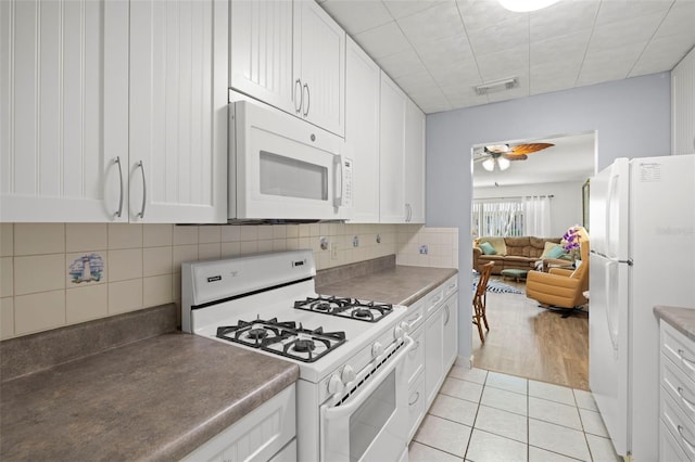 kitchen with light tile patterned flooring, white appliances, ceiling fan, white cabinetry, and visible vents