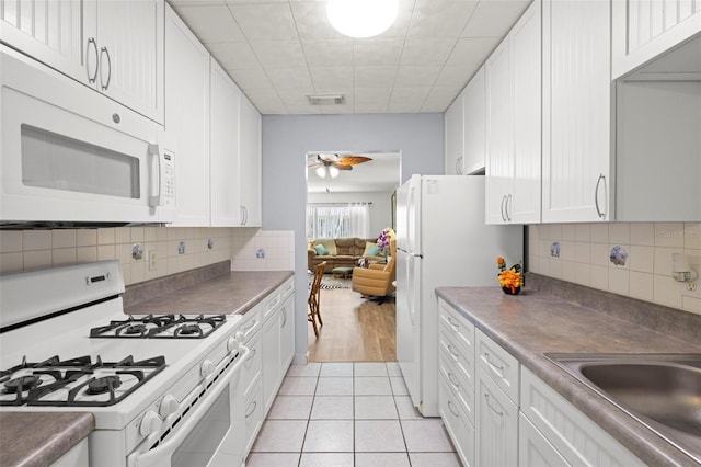 kitchen with a ceiling fan, light tile patterned flooring, white appliances, white cabinetry, and visible vents