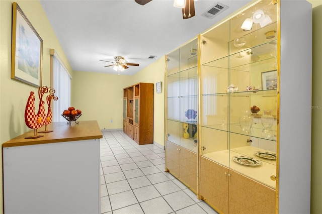 corridor featuring visible vents and light tile patterned floors