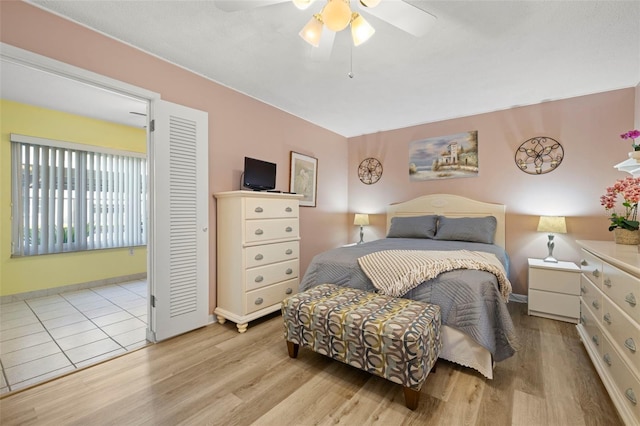 bedroom with ceiling fan, baseboards, and wood finished floors