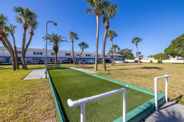 view of property's community with a residential view and a yard