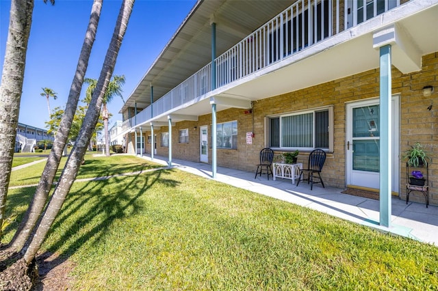 view of yard with a balcony and a patio