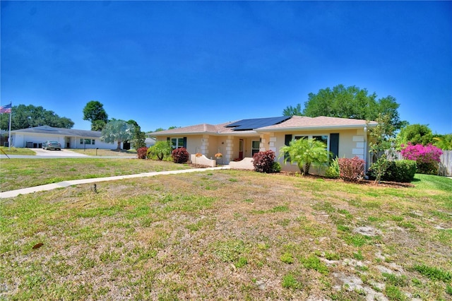 53 Paine Dr, Winter Haven, FL 33884 - ranch-style home with roof mounted solar panels and a front lawn