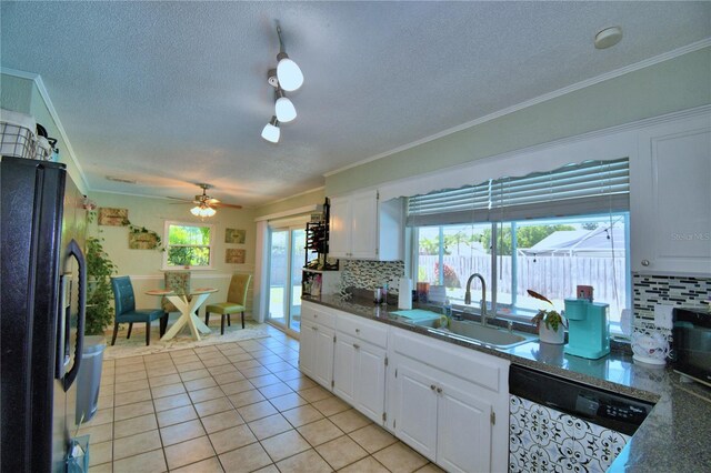 53 Paine Dr, Winter Haven, FL 33884 - kitchen featuring a textured ceiling, a sink, freestanding refrigerator, backsplash, and dishwashing machine