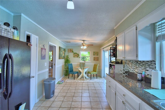 53 Paine Dr, Winter Haven, FL 33884 - kitchen with white cabinets, freestanding refrigerator, a textured ceiling, and a ceiling fan