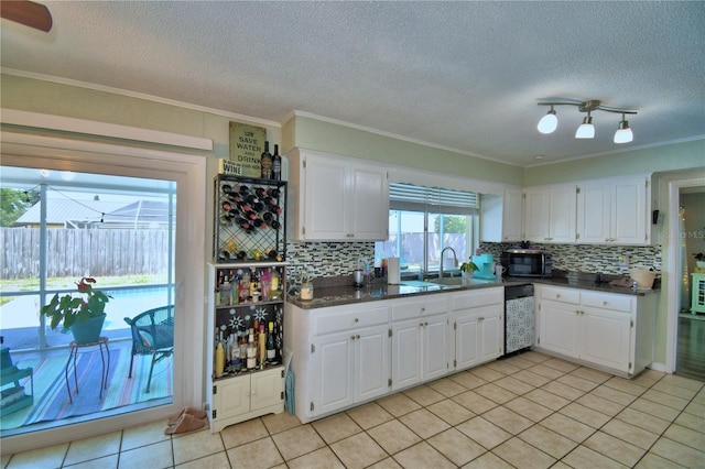 53 Paine Dr, Winter Haven, FL 33884 - kitchen featuring backsplash, black microwave, dark countertops, and a sink