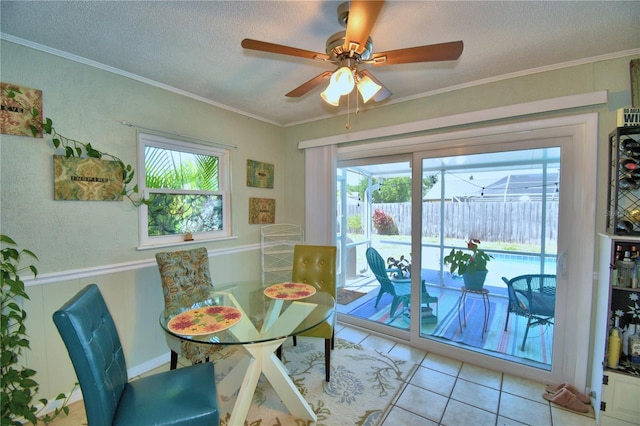 53 Paine Dr, Winter Haven, FL 33884 - dining area featuring a textured ceiling, a wainscoted wall, ceiling fan, and light tile patterned floors