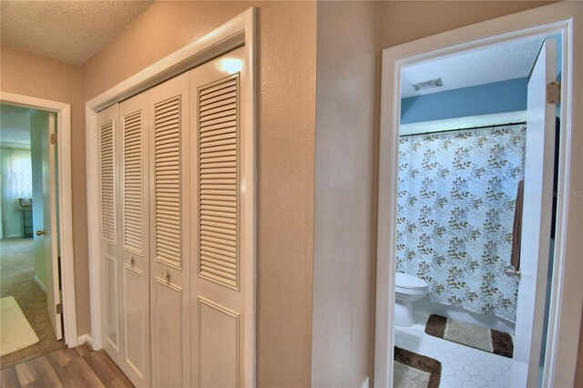 53 Paine Dr, Winter Haven, FL 33884 - hall featuring dark wood finished floors, a textured ceiling, and visible vents