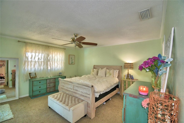 53 Paine Dr, Winter Haven, FL 33884 - bedroom featuring visible vents, ornamental molding, a textured ceiling, carpet flooring, and ceiling fan