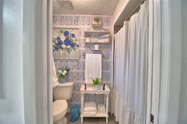 53 Paine Dr, Winter Haven, FL 33884 - bathroom with a textured ceiling, visible vents, toilet, and tile patterned floors