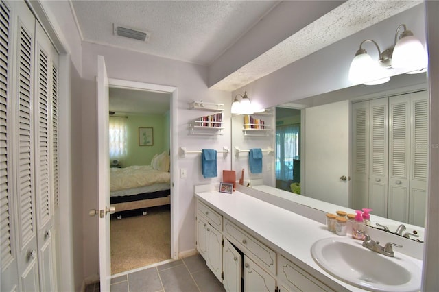 53 Paine Dr, Winter Haven, FL 33884 - bathroom with a textured ceiling, tile patterned floors, a closet, ensuite bath, and visible vents