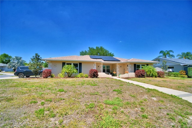 53 Paine Dr, Winter Haven, FL 33884 - ranch-style home with solar panels and a front lawn
