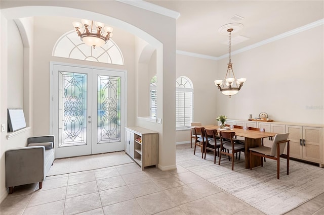 17206 Emerald Chase Dr, Tampa, FL 33647 - entryway featuring ornamental molding, french doors, arched walkways, light tile patterned floors, and a notable chandelier
