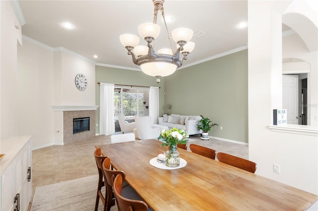 17206 Emerald Chase Dr, Tampa, FL 33647 - dining area featuring light tile patterned floors, ornamental molding, a tile fireplace, and a notable chandelier