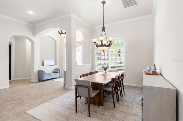 17206 Emerald Chase Dr, Tampa, FL 33647 - dining area featuring visible vents, ornamental molding, arched walkways, and a chandelier