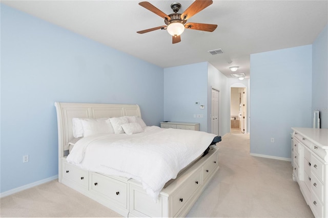17206 Emerald Chase Dr, Tampa, FL 33647 - bedroom with arched walkways, baseboards, light carpet, and ensuite bath