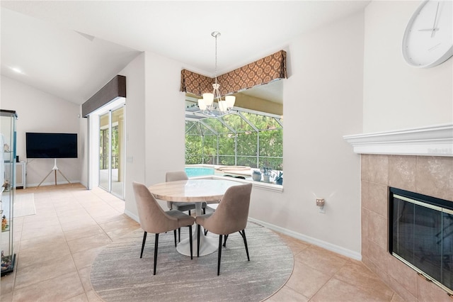 17206 Emerald Chase Dr, Tampa, FL 33647 - dining area with a chandelier, a fireplace, baseboards, lofted ceiling, and light tile patterned flooring
