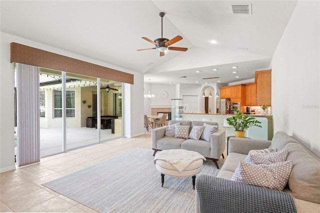 17206 Emerald Chase Dr, Tampa, FL 33647 - living room with light tile patterned flooring, visible vents, and ceiling fan with notable chandelier