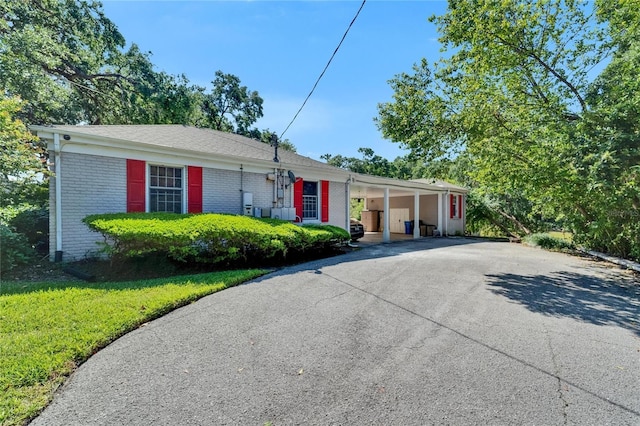 1603 Cottagewood Dr, Brandon, FL 33510 - single story home with brick siding, driveway, and an attached carport
