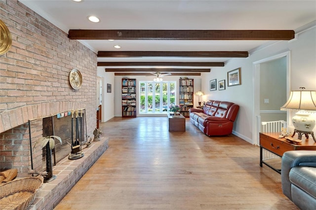 1603 Cottagewood Dr, Brandon, FL 33510 - living area featuring a ceiling fan, light wood-type flooring, beam ceiling, baseboards, and a fireplace