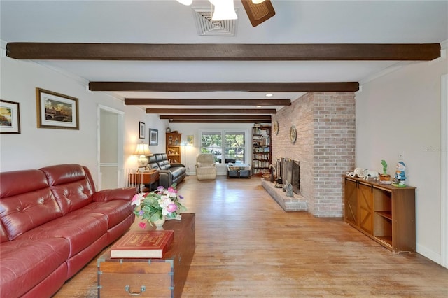 1603 Cottagewood Dr, Brandon, FL 33510 - living area featuring a ceiling fan, light wood-style floors, a brick fireplace, beam ceiling, and visible vents