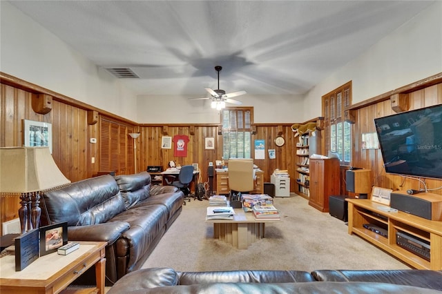 1603 Cottagewood Dr, Brandon, FL 33510 - carpeted living room featuring wainscoting, wooden walls, a ceiling fan, and visible vents