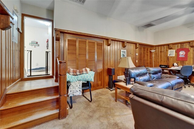 1603 Cottagewood Dr, Brandon, FL 33510 - living room featuring wooden walls, visible vents, and light carpet