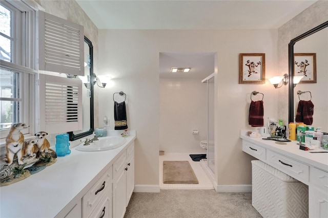 1603 Cottagewood Dr, Brandon, FL 33510 - bathroom with baseboards, a shower stall, a wealth of natural light, and vanity