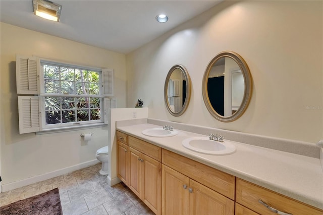 1603 Cottagewood Dr, Brandon, FL 33510 - full bathroom with baseboards, a sink, double vanity, and toilet