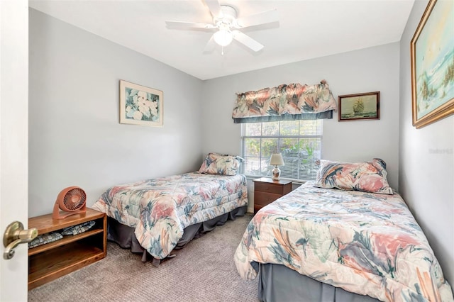 bedroom featuring a ceiling fan and carpet