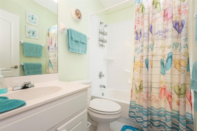 bathroom with toilet, shower / bath combo with shower curtain, and vanity