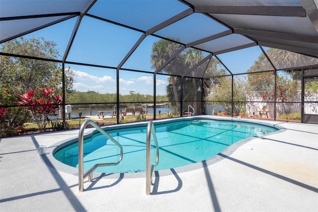 outdoor pool featuring a lanai, a water view, and a patio