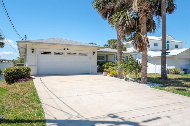 ranch-style home with driveway, stucco siding, fence, a front lawn, and a garage